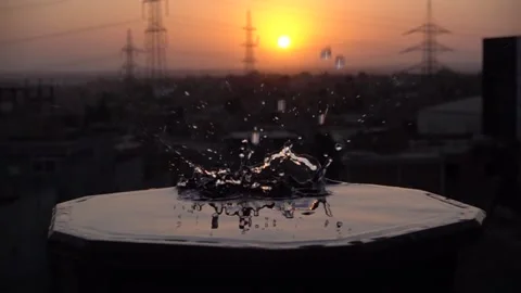 Sunset with a drop of water splash in slow motion 240fps Stock Footage 157223716