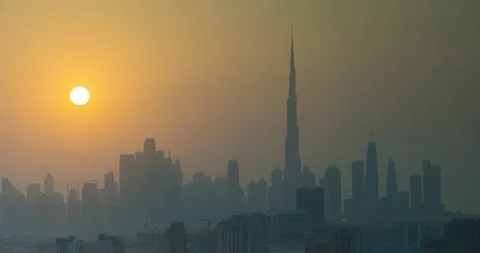 Sunset in Dubai view to downtown, time lapse. Sun sets over the skyscrapers or Stock Footage 131387206