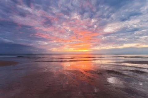 Sunset ebb at tropical beach Stock Photos