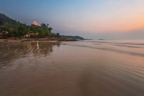 Sunset ebb at tropical beach Stock Photos