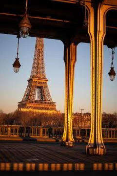 Sunset on the Eiffel Tower and Pont de Bir Hakeim bridge in Paris Stock Photos