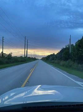 Sunset on an empty two lane road Stock Photos