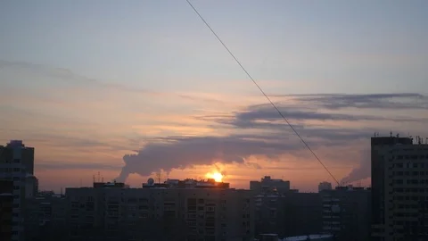 Sunset evening in the city on a background of smoking pipes, 4k Stock Footage 72243685
