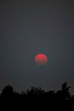 Sunset the evening light through the clouds and  trees. Stock Photos