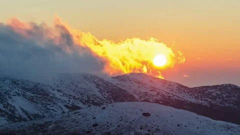 Sunset evening over winter alpine mountains with clouds snowy nature Time lapse Stock Footage 106712236