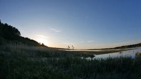 Sunset evening sky over the calm lake in timelapse 4K video with no people. Video stock 106915506