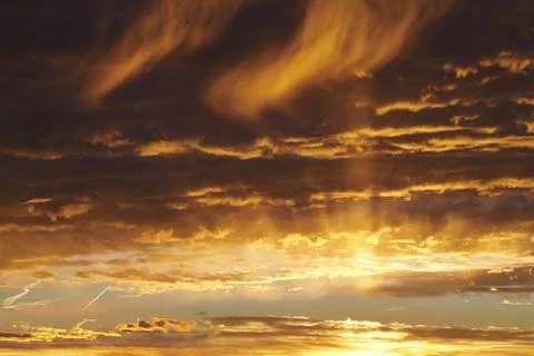 Sunset evening sky. Sun in the clouds Stock Photos