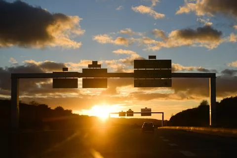 Sunset facing while driving on a road Stock Photos