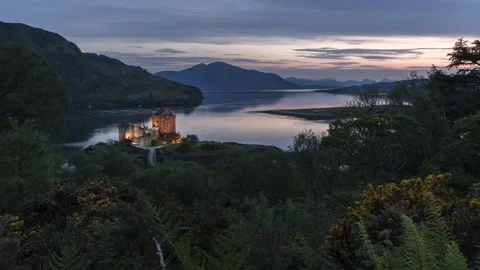 Sunset at the famous Eilean Donan Castle in Scotland with lochs and mountains Stock Footage 173494732