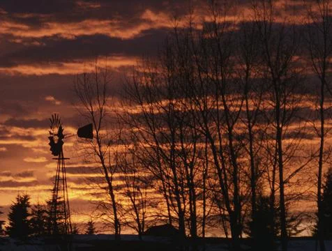 Sunset At Farm With Windmill Stock Photos