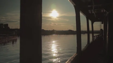 Sunset. The ferry approaches the shore 動画素材 78156487