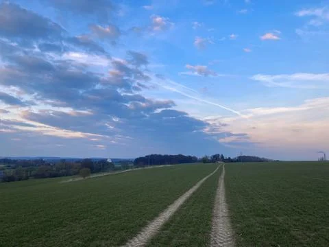 Sunset on a field with beautiful clouds 写真素材