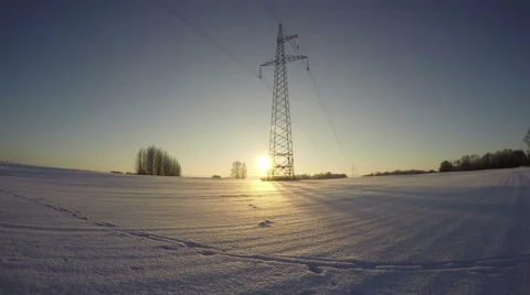 Sunset in the field with electrical pylon in winter, time lapse 4K Stock Footage 58956335