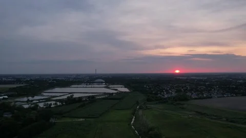 Sunset, fish breeding ponds, a hall with a cycling track, a panorama Stock Footage 242530560