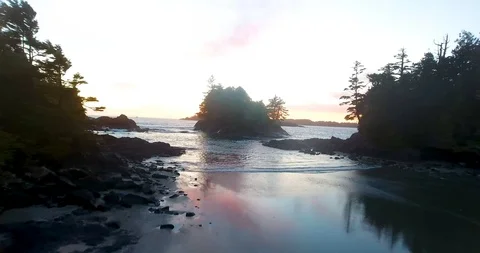 Sunset flight over beach and water Stockbeeldmateriaal 90680289