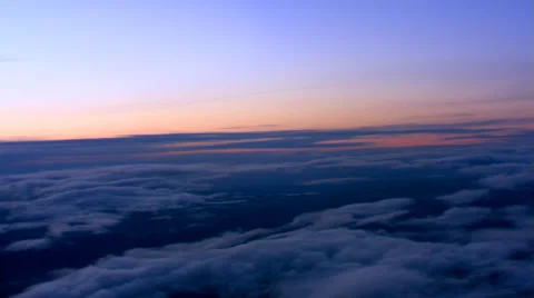 Sunset flight over broken cloud layer over rugged terrain, passenger POV Video stock 59538001