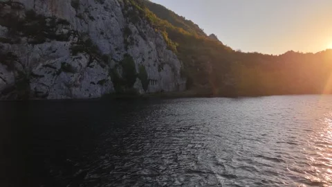 Sunset Flight Over River Passing Ancient Tomb in Scenic Valley Stock Footage 337265623