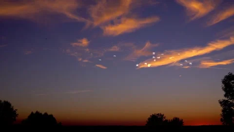 Sunset Flight: Seagulls Soaring Through Orange Clouds Stock Footage 325329304