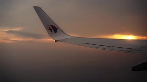 Sunset flight in the sky through an airplane window Stock Footage 292946919