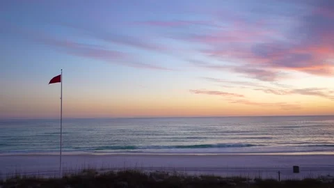 Sunset on Florida Beach. Red Warning Flag Waving. Signaling Hazardous Swimm.. Stock Footage 336922119