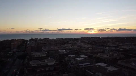 Sunset flying from a seaside town Stock Footage 145936426