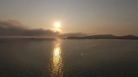 Sunset footage over the calm Pacific ocean with blue skies the background. Stock Footage 104051379