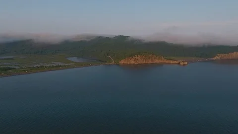 Sunset footage over the calm Pacific ocean with blue skies the background. Stock Footage 104055298
