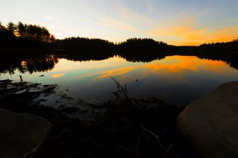 Sunset on a forest lake. Stock Photos