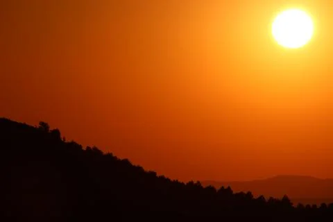 Sunset in the forest. mountain, forest and sun. beautiful sunset landscape Stock Photos