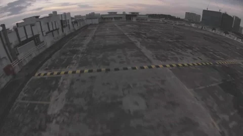 Sunset FPV Drone Flyaround Over Kuala Lumpur Rooftop Parking 03 Stock Footage 303755013