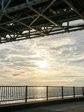 Sunset Framed by Bridge Structure at Kobe Waterfront Stock Photos