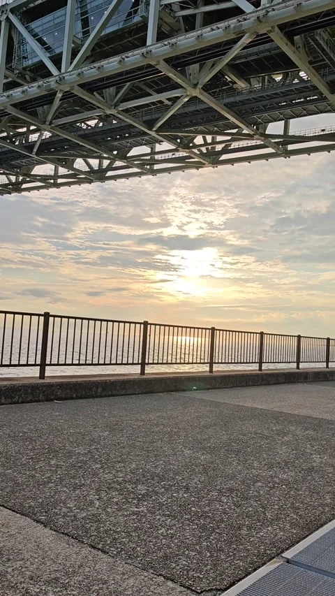 Sunset Framed by the Structure of Akashi Kaikyō Bridge Stock Footage 321434904