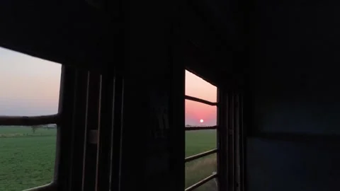 Sunset Framed by Train Window Bars During Indian Rail Journey Stock Footage 323865426