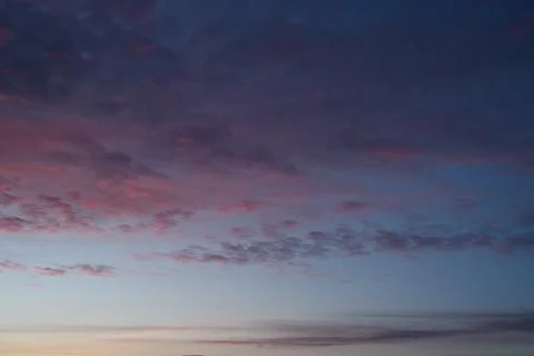 A sunset full of colors. Fluffy clouds. Romantic sky. Universal horizontal photo Stock Photos