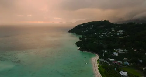Sunset glow with clouds over calm ocean and coastline. Seychelles, Mahe. Stock Footage 318692035