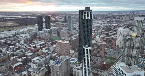 Sunset glow over Jersey City towers and rowhouse blocks Stock Footage 258326976