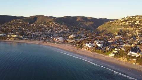 Sunset Glow Over Laguna Beach with Surfers in the Water Stock Footage 300850285