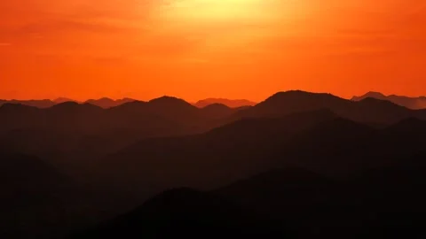 Sunset Glow Over silhouette layer Mountain Horizon in Aerial Cinematic Scenic Stock Footage 319007326
