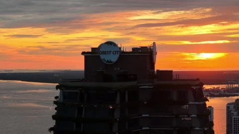 Sunset glow reflecting off the sleek facade of the Carnelian Tower Stock Footage 332087992