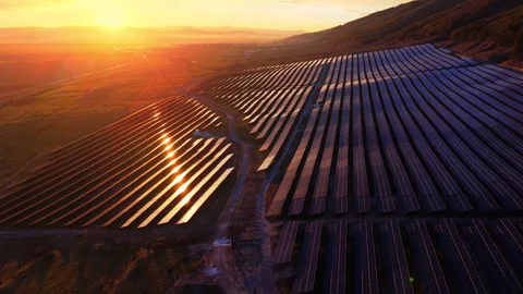 Sunset glow reflecting on solar farm hillside, Bulgaria Stock Footage 336724848