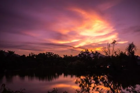 Sunset glow in the sky with reflection from the lake. Stock Photos