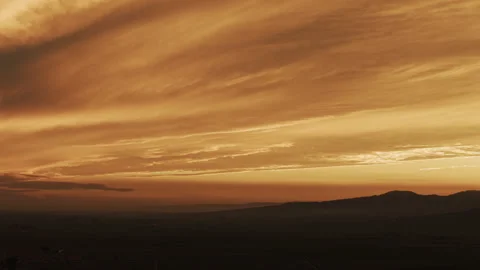 Sunset Glowing Stratus Clouds Silhouette Dramatic Sky Tracking 8K HLG Stock Footage 344016013