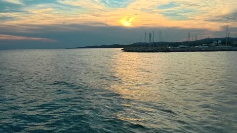 Sunset glows on calm ocean waves. Lagomandra, Greece Stock-Footage 339024307