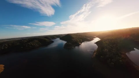 Sunset glows over calm, winding river Video stock 342187703