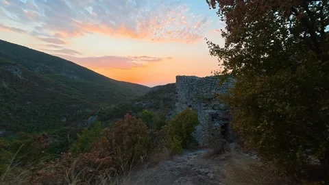 Sunset glows through green and autumn leaves. Soko Grad, Serbia 動画素材 345897553