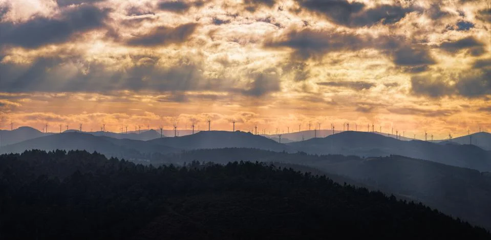 Sunset Golden Cloudscape over a Wind Farm Stock Photos