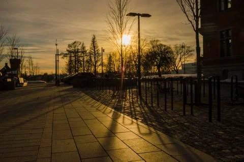 Sunset golden hour reflection shadow of iron architechture in an outdoor park Stock Photos