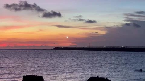 Sunset golden hour view of beach with orange sky Stock Footage 238860093