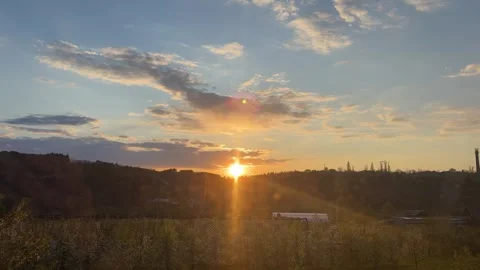 Sunset, golden light illuminating tranquil natural landscape, glowing horizon, Stock Footage 333776738