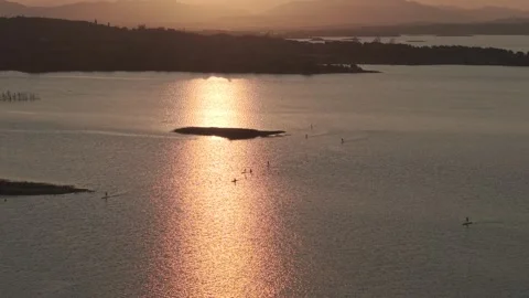 Sunset Golden Reflection on Lake with Paddlers Stock-Footage 345035804
